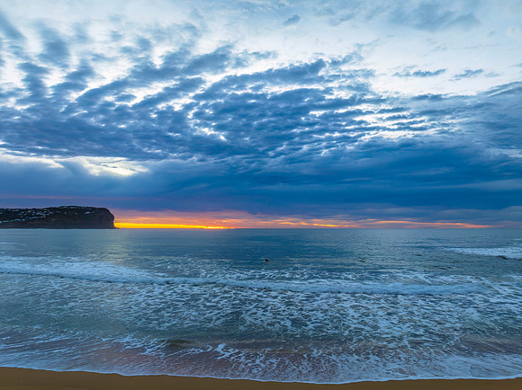 Cloud filled sunrise seascape
