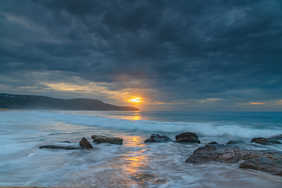Sunrise at the seaside with rocks and beautiful diffused light b