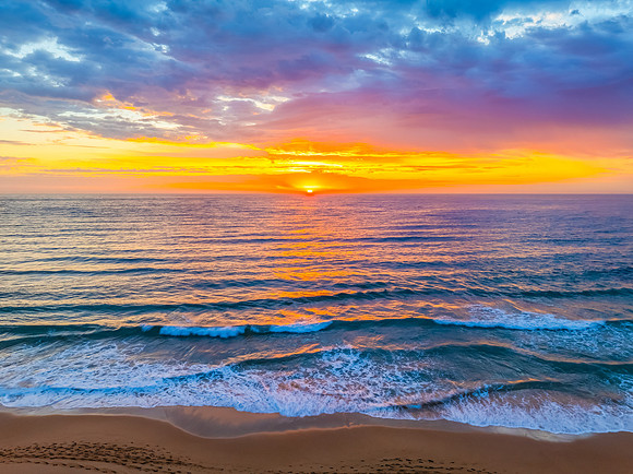 Pretty Sunrise at the seaside with rain clouds