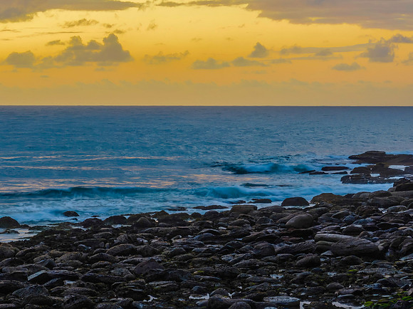 Drizzly moody sunrise seascape with cloud filled sky