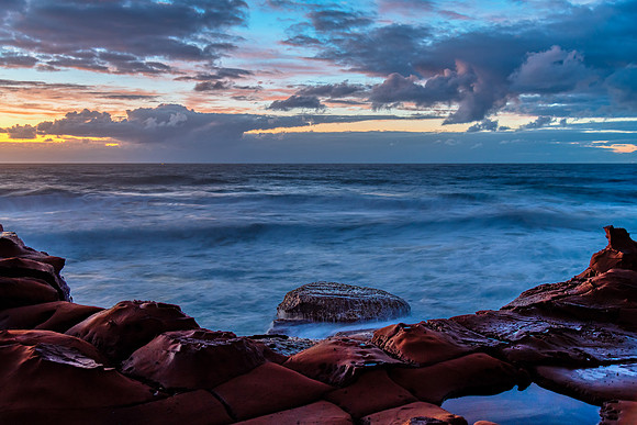 Sunrise, sea, waves, clouds and tessellated rock platform