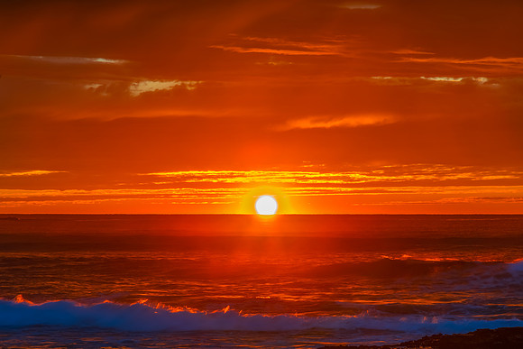 Winter sunrise by the sea shore with rain clouds