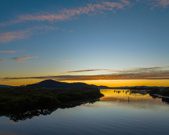 High cloud sunrise over the bay water