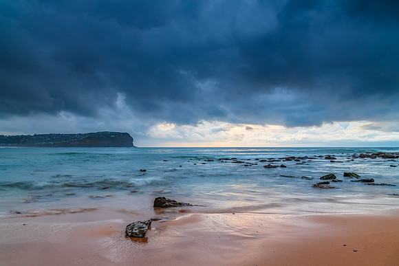 Cloud covered sunrise at the seaside