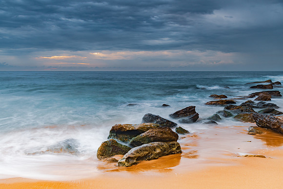 Sunrise at the seaside with rocks and beautiful diffused light b