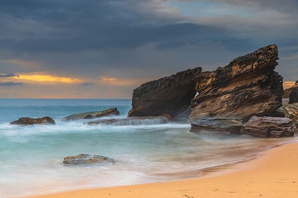 Sunrise at the seaside with rocks and beautiful diffused light b