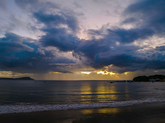 Aerial sunrise at the seaside with rain clouds