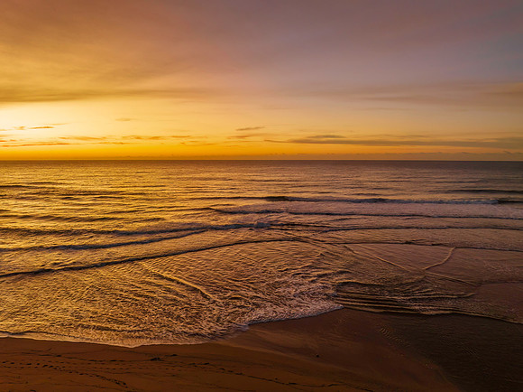 Sunrise and high cloud cover by the sea and lagoon
