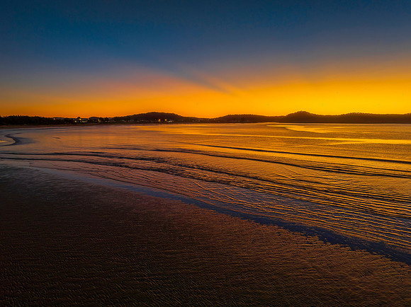 Aerial sunrise seascape with orange glow on a cold Winter's morn