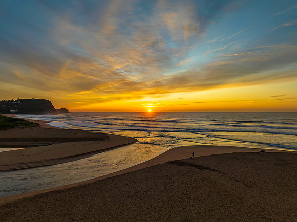 Sunrise and high cloud cover by the sea and lagoon