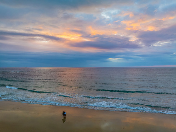 Sunrise Seascape with beautiful cloud covered sky and gentle sur