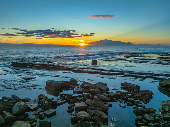 Sunrise over the ocean and rocky Inlet