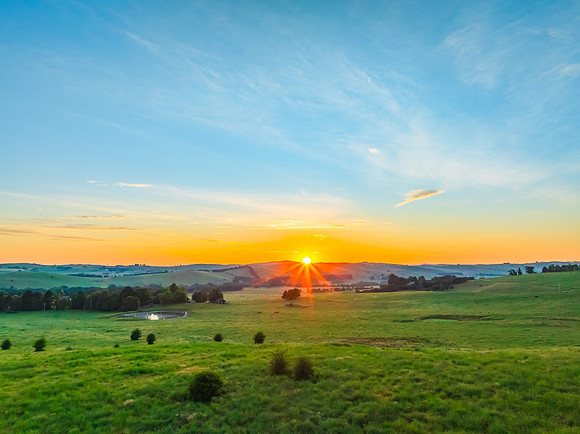 Sunrise over the countryside on the outskirts of country town wi