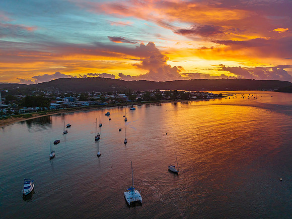 Aerial sunrise waterscape with boats, colour and clouds