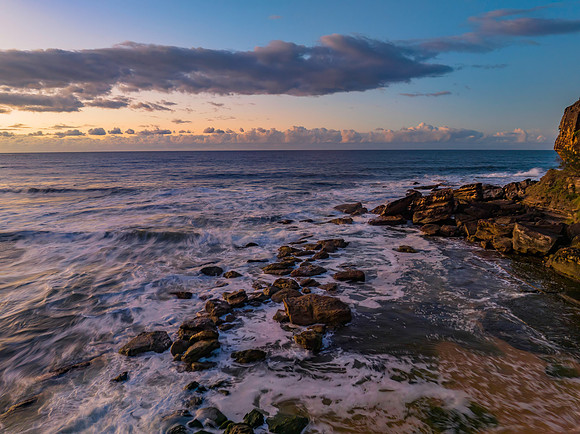 Aerial sunrise at the beach with clouds
