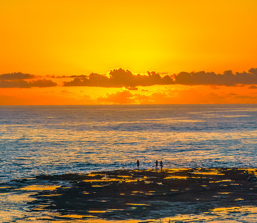 Sunrise over the sea and rocks with clear skies