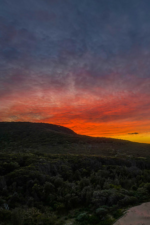 High cloud sunrise over the beach and mountain