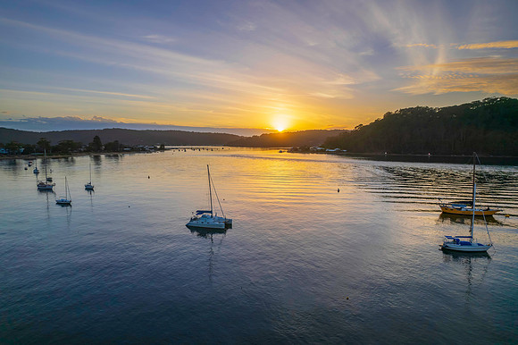 Aerial sunrise waterscape with boats