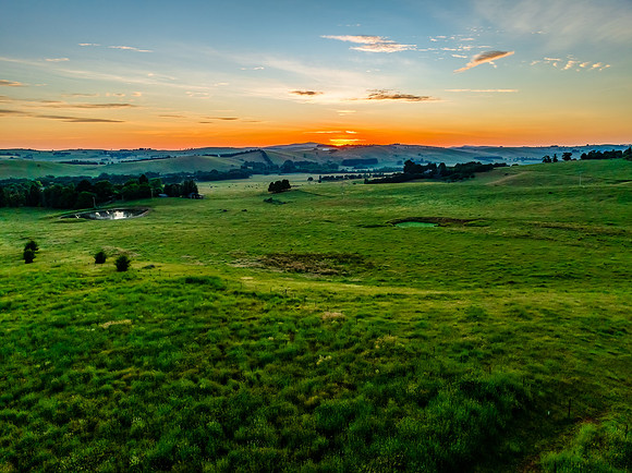Sunrise over the countryside on the outskirts of country town wi