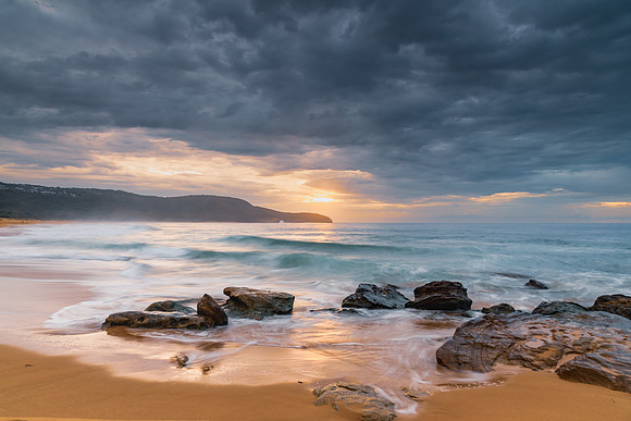 Sunrise at the seaside with rocks and beautiful diffused light b