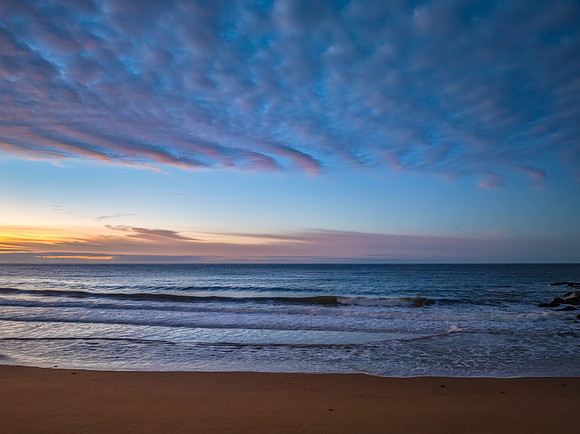 Winter seascape views over the beach with high and medium cloud