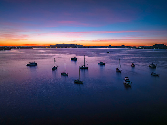 Dawn Colour Palette over the bay with boats and high cloud