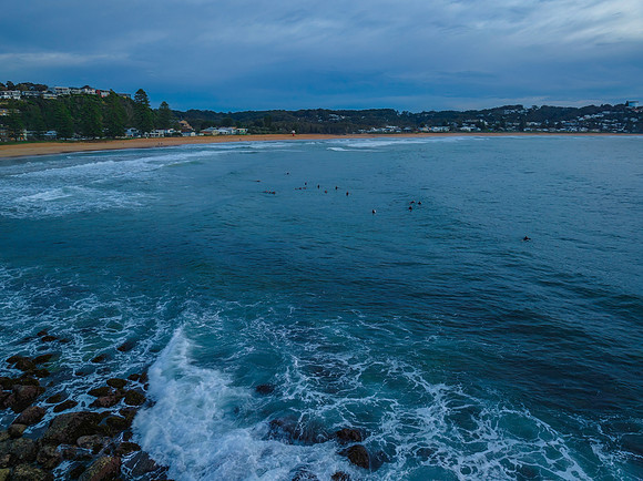 Aerial sunrise at the seaside in shades of blue and grey