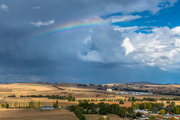Late afternoon country views with clouds and a rainbow from the
