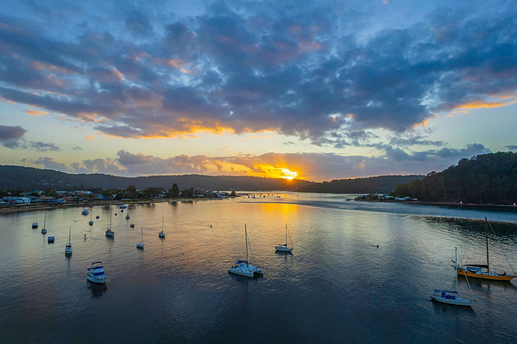 Aerial sunrise waterscape with boats
