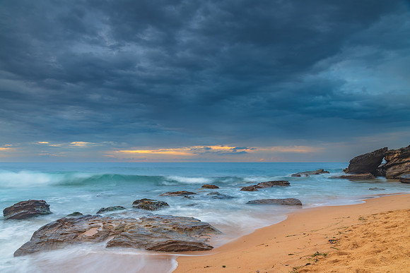 Sunrise at the seaside with rocks and beautiful diffused light b