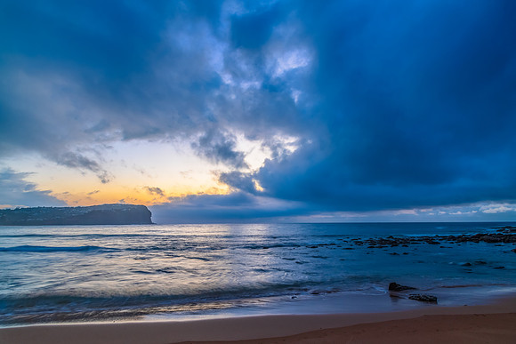 Cloud covered sunrise at the seaside