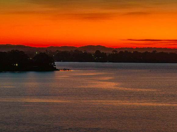 Aerial sunrise waterscape with boats and high cloud