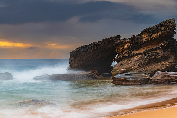 Sunrise at the seaside with rocks and beautiful diffused light b