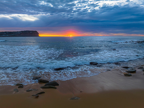 Cloud filled sunrise seascape