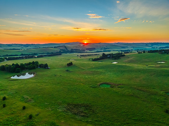 Sunrise over the countryside on the outskirts of country town wi