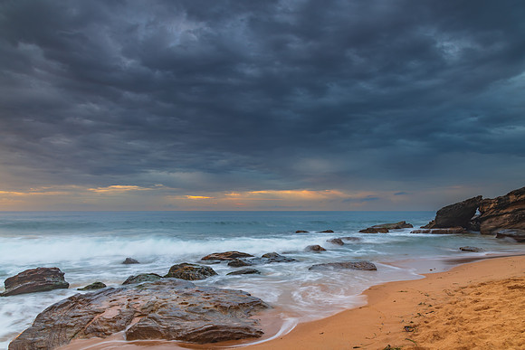 Sunrise at the seaside with rocks and beautiful diffused light b