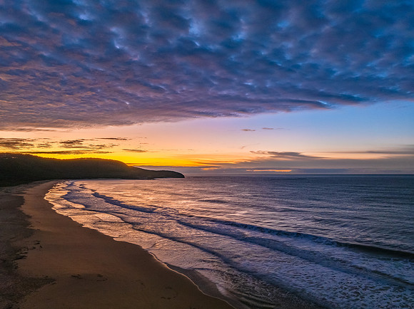 Winter seascape views over the beach with high and medium cloud