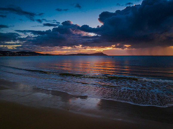 Aerial sunrise at the seaside with rain clouds