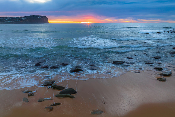 Cloud filled sunrise seascape