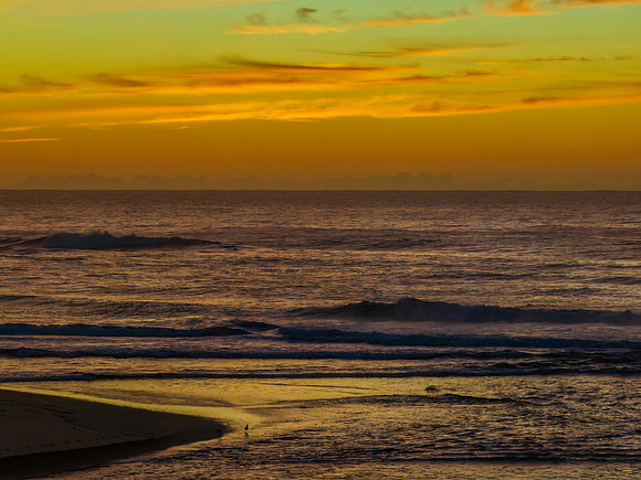 Sunrise and high cloud cover by the sea and lagoon