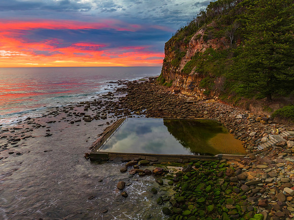 Cloud filled sunrise seascape and sea pool