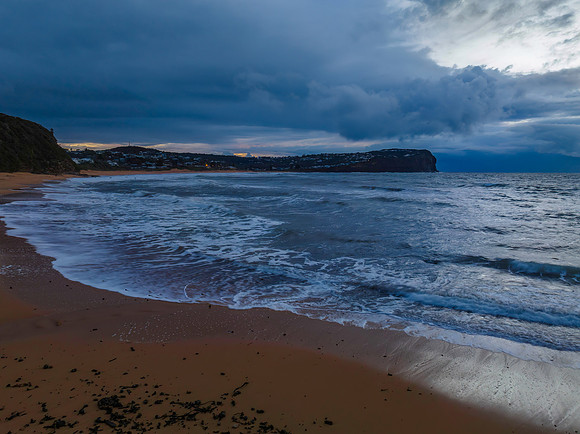 Moody sunrise seascape with rain clouds