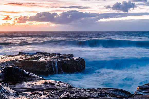 Sunrise, sea, waves, clouds and tessellated rock platform