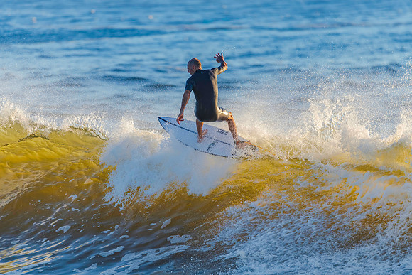 Early morning surfer and waves at the seaside