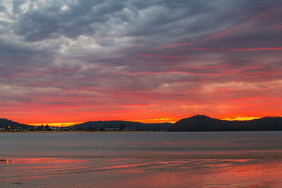 Colourful cloud filled sunrise at the seaside