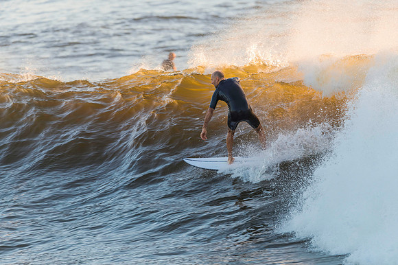 Early morning surfer and waves at the seaside