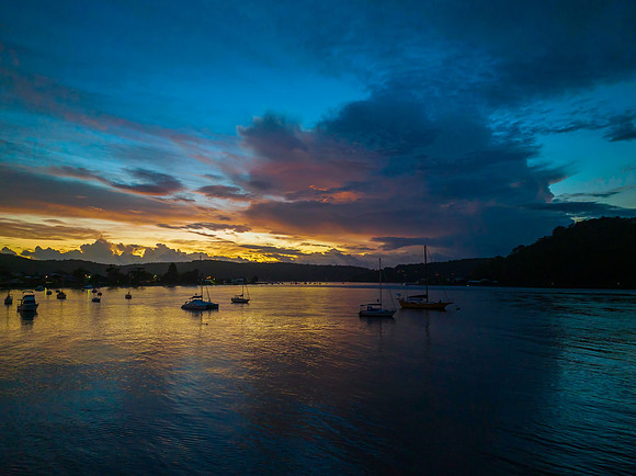 Aerial sunrise waterscape with boats, colour and clouds