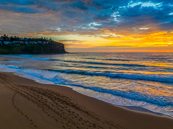 Pretty Sunrise at the seaside with rain clouds