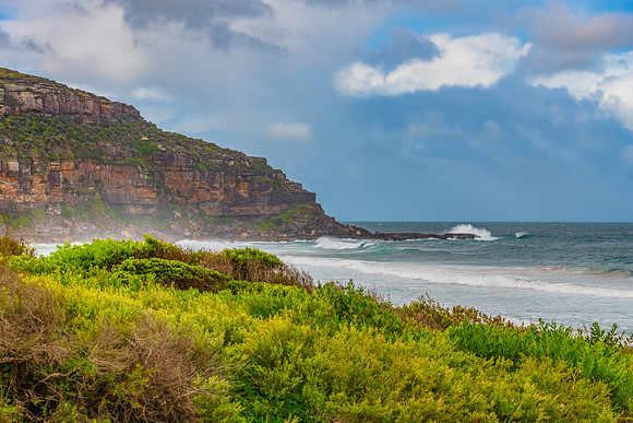 Scenic views at the seaside with waves and clouds in the sky
