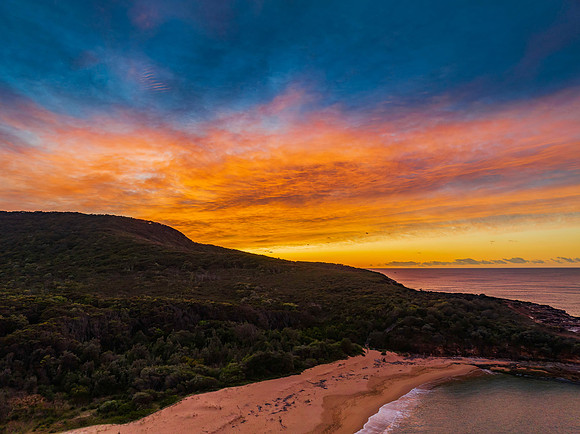 High cloud sunrise over the beach and mountain